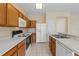 Bright kitchen features wood cabinets, white appliances, and tile flooring at 319 Sand Ridge Dr, Davenport, FL 33896