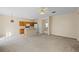Living room features carpet, neutral walls, and kitchen access at 319 Sand Ridge Dr, Davenport, FL 33896