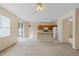 Open living room with view of kitchen and access to backyard at 319 Sand Ridge Dr, Davenport, FL 33896