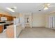 Open living room with kitchen, and access to hallway at 319 Sand Ridge Dr, Davenport, FL 33896
