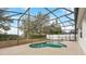 Sparkling pool with screened enclosure and lush greenery at 319 Sand Ridge Dr, Davenport, FL 33896
