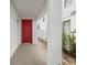 Red door leading to a covered side patio at 319 Sand Ridge Dr, Davenport, FL 33896