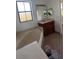 Bathroom with corner tub, vanity, and tiled floor at 3459 Allegra Cir, St Cloud, FL 34772