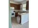 Kitchen with wood cabinets and white appliances at 3459 Allegra Cir, St Cloud, FL 34772