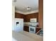 Kitchen with wood cabinets, white appliances, and light countertops at 3459 Allegra Cir, St Cloud, FL 34772
