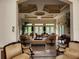 Bright and open lounge area with high decorative ceilings, tile flooring, neutral furniture, and multiple French doors at 3459 Allegra Cir, St Cloud, FL 34772