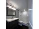 Bathroom with dark vanity, white countertop and tiled shower at 4575 S Texas Ave # 207, Orlando, FL 32839