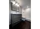Bathroom with gray vanity, white countertop and tiled shower at 4575 S Texas Ave # 207, Orlando, FL 32839
