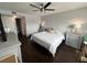 Bedroom featuring neutral walls, ceiling fan, dark wood floors, and bedside tables at 4575 S Texas Ave # 207, Orlando, FL 32839