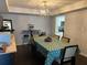 Well-lit dining room with a modern light fixture, wood floors, and open access to the kitchen at 4575 S Texas Ave # 207, Orlando, FL 32839