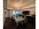 Charming dining area with a modern light fixture, wood floors, and seamless transition to the living room at 4575 S Texas Ave # 207, Orlando, FL 32839