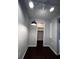 Hallway leading to a closet, accented with modern track lighting and neutral paint at 4575 S Texas Ave # 207, Orlando, FL 32839