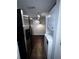 Convenient kitchen layout with a refrigerator and a stacked washer and dryer at 4575 S Texas Ave # 207, Orlando, FL 32839