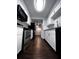 Galley kitchen featuring white cabinets, stainless steel appliances, granite countertops, and subway tile backsplash at 4575 S Texas Ave # 207, Orlando, FL 32839