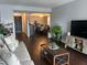 Comfortable living space featuring wooden flooring, a couch, and a view into the dining area at 4575 S Texas Ave # 207, Orlando, FL 32839