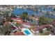 Overhead view of a community, highlighting the pool and surrounding natural landscape with a lake at 46 W Marbrisa Way, Kissimmee, FL 34743