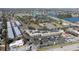 Aerial view of a community with a shopping center nearby, featuring lakes and lush greenery at 46 W Marbrisa Way, Kissimmee, FL 34743