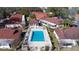 Aerial view of a community pool with red roofs, and lush greenery at 46 W Marbrisa Way, Kissimmee, FL 34743