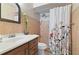 Clean bathroom with shower/tub combo and floral shower curtain at 46 W Marbrisa Way, Kissimmee, FL 34743