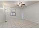 Bright bedroom featuring tile floors and a ceiling fan at 46 W Marbrisa Way, Kissimmee, FL 34743