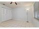 Well-lit bedroom with tile floors and ample closet space at 46 W Marbrisa Way, Kissimmee, FL 34743