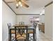 Dining area with glass-top table and four chairs, open to living room at 46 W Marbrisa Way, Kissimmee, FL 34743