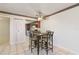 Dining area with glass table, four chairs, and kitchen access at 46 W Marbrisa Way, Kissimmee, FL 34743