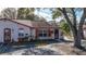 Charming single-story villa with red trim, shutters, and designated guest parking at 46 W Marbrisa Way, Kissimmee, FL 34743