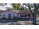 Inviting single-story home featuring red trim, shutters, and designated parking for residents and guests at 46 W Marbrisa Way, Kissimmee, FL 34743