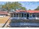 Home features screened porch and mature trees at 46 W Marbrisa Way, Kissimmee, FL 34743