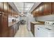 Kitchen with wood cabinets and appliances, open to dining area at 46 W Marbrisa Way, Kissimmee, FL 34743
