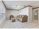 Living room features tiled floors, sofa, chair, and ottoman near window at 46 W Marbrisa Way, Kissimmee, FL 34743