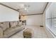 Living room with tiled floors, sofa, ottoman, and ceiling fan at 46 W Marbrisa Way, Kissimmee, FL 34743