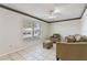 Bright living area showcasing tile flooring, a ceiling fan and comfortable seating at 46 W Marbrisa Way, Kissimmee, FL 34743