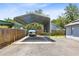 Metal carport with a blue covered boat at 4755 Oakwood Dr, St Cloud, FL 34772