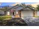 Two-story house with gray siding, stone accents, and a two-car garage at 4755 Oakwood Dr, St Cloud, FL 34772