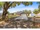 Charming one-story home with a spacious driveway, complemented by mature trees and a wooden fence at 4755 Oakwood Dr, St Cloud, FL 34772