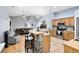 Open kitchen with island, stainless steel appliances, and breakfast bar at 4755 Oakwood Dr, St Cloud, FL 34772