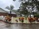 Landscaped backyard with a white picket fence at 5030 Haywood Ruffin Rd, St Cloud, FL 34771