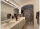 Clean bathroom with double sinks, shower/tub combo, and updated vanity at 5030 Haywood Ruffin Rd, St Cloud, FL 34771