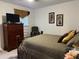 Bedroom with a large bed, dresser and plenty of space at 5030 Haywood Ruffin Rd, St Cloud, FL 34771