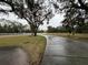 Long driveway winding through a tree-lined landscape at 5030 Haywood Ruffin Rd, St Cloud, FL 34771