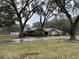 Brick ranch home nestled amongst large oak trees on a spacious lot at 5030 Haywood Ruffin Rd, St Cloud, FL 34771