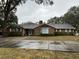 Brick ranch home with a large front yard and driveway at 5030 Haywood Ruffin Rd, St Cloud, FL 34771