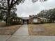 Brick house with a wide driveway and lush green lawn at 5030 Haywood Ruffin Rd, St Cloud, FL 34771