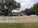 Ranch-style home behind a white fence, offering curb appeal at 5030 Haywood Ruffin Rd, St Cloud, FL 34771