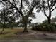 Mature trees and lush lawn characterize this front yard at 5030 Haywood Ruffin Rd, St Cloud, FL 34771