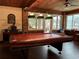 Game room featuring a pool table and wood-paneled walls at 5030 Haywood Ruffin Rd, St Cloud, FL 34771
