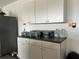 Garage features white cabinets and countertop space at 5030 Haywood Ruffin Rd, St Cloud, FL 34771
