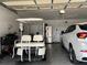 Spacious garage with golf cart, refrigerator, and ample storage at 5030 Haywood Ruffin Rd, St Cloud, FL 34771